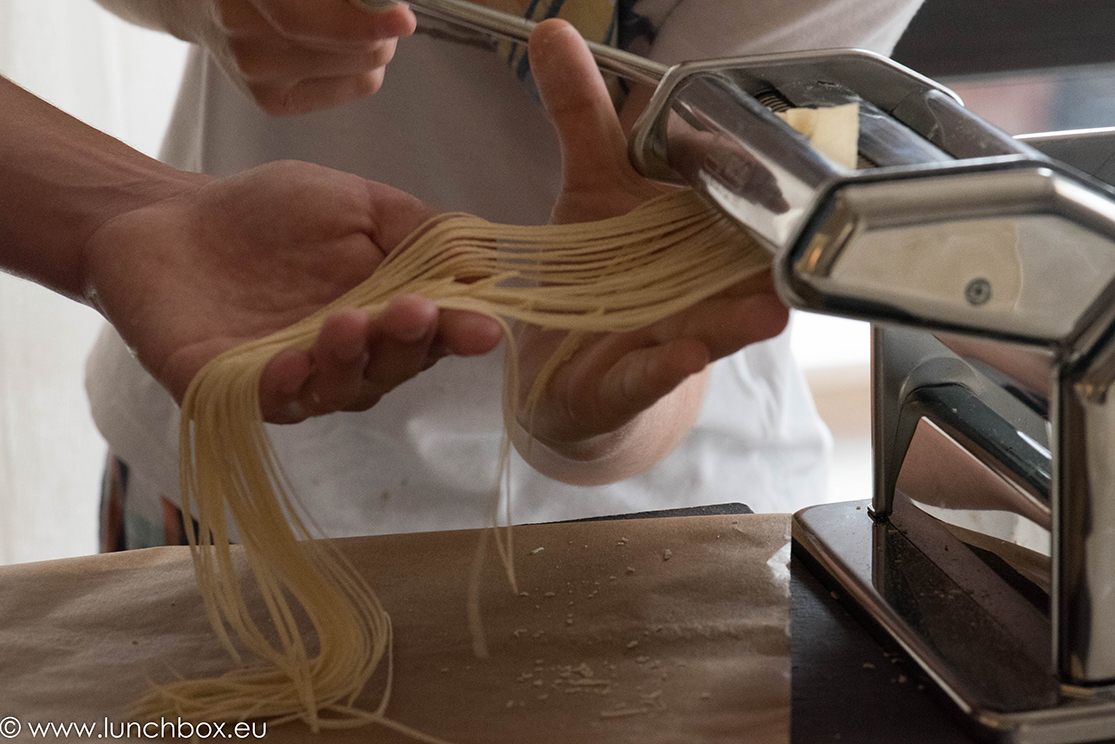 rolling pasta dough with machine