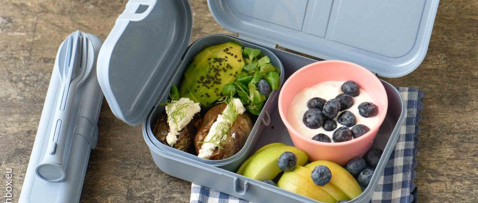 Healthy school lunchbox with baked potatoes