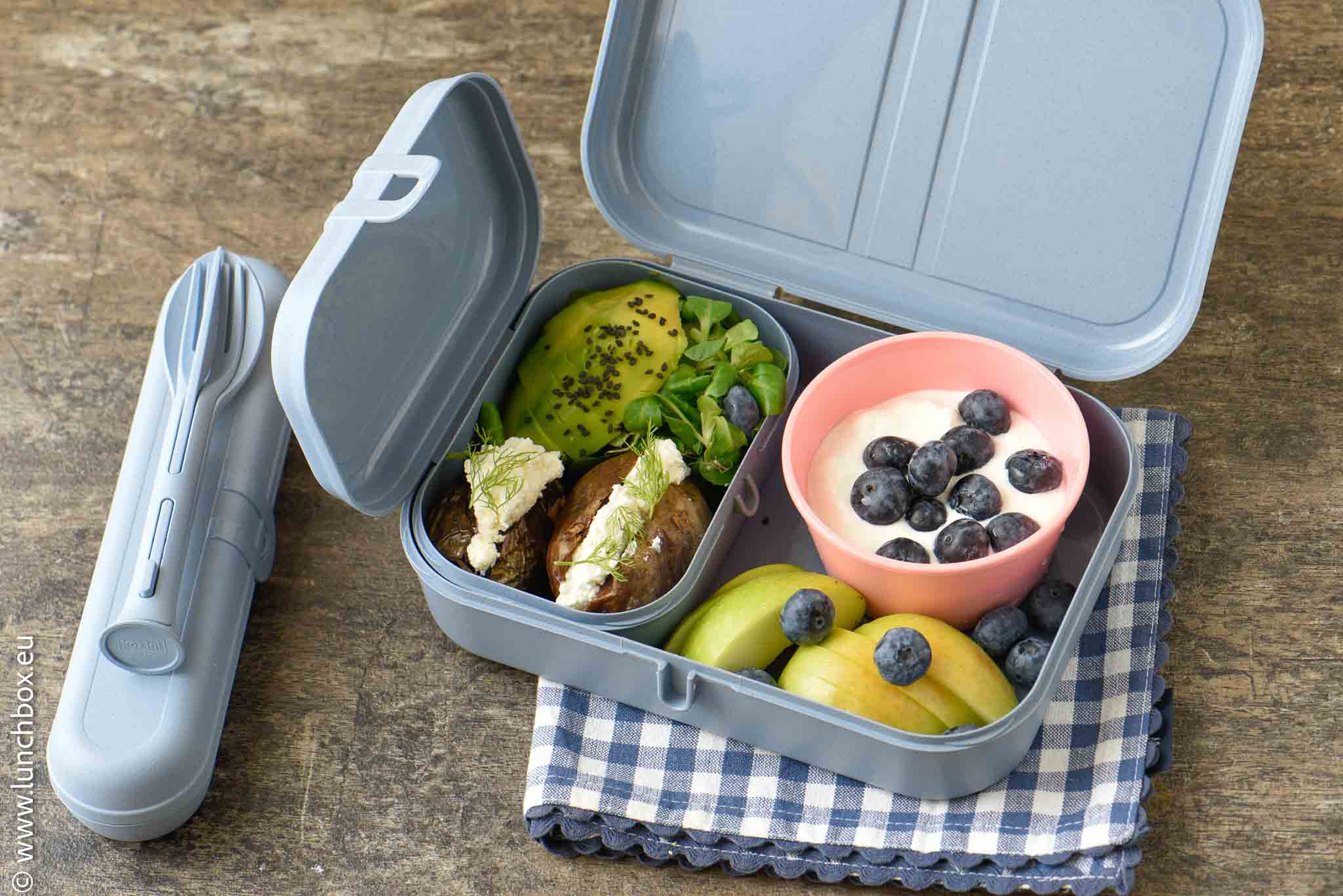Healthy school lunchbox with baked potatoes